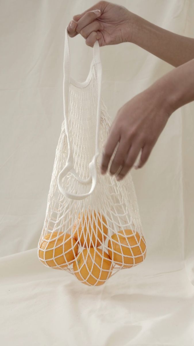 A net bag of oranges, carried home